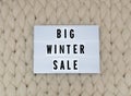BIG WINTER SALE word on lightbox on knit background. Cozy compozition. Knit background. Royalty Free Stock Photo
