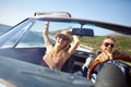 Lets just keep driving. A happy young couple driving in a convertible on a bright summers day.