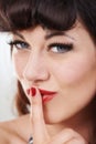 Lets keep this between us...Cropped view of a sultry woman with her finger to her lips. Royalty Free Stock Photo