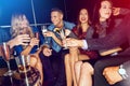 Lets kick this party into high gear. a group of friends toasting with drinks at a party. Royalty Free Stock Photo