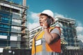 Lets leave male dominated industries in the dark ages. a young woman using a smartphone while working at a construction Royalty Free Stock Photo