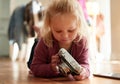 Lets make today a remarkable one. an adorable little girl playing with a camera. Royalty Free Stock Photo