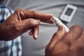 Lets not sugarcoat it, diabetes can be dangerous. an unrecognisable man using a blood sugar test on his finger in bed at Royalty Free Stock Photo