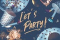 Lets party hand brush stroke font on marble table with party cup,party blower,tinsel,confetti.Fun Celebrate holiday party time Royalty Free Stock Photo