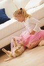 Lets play ballerina together. a little girl in a tutu playing with a puppy. Royalty Free Stock Photo