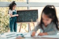 Lets rearrange the alphabet. a young girl writing on a blackboard. Royalty Free Stock Photo