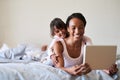 Lets see whats trending in the world today. a beautiful young mother and daughter using a digital tablet while relaxing