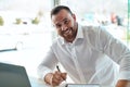 Lets sell some cars. a young car salesman filling out paperwork in his office. Royalty Free Stock Photo