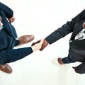 Lets shake on it. High angle shot of two businesspeople shaking hands in an office. Royalty Free Stock Photo