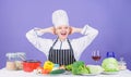 Lets start cooking. Woman chef cooking healthy food. Gourmet main dish recipes. Girl in hat and apron. Delicious recipe Royalty Free Stock Photo