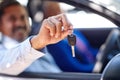 Lets take a drive. a senior man sitting in a car with his wife and showing you his keys.