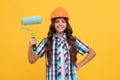 lets work. happy teen girl hold paint roller. child in helmet. roller brush for decoration.