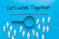 Lets Work Together Sign on white paper. Man Hand Holding Paper with text. Isolated on Workers concept, Magnifying glass. Blue