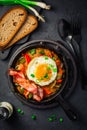 Letscho - tasty Hungarian vegetable stew with peppers, tomatoes and onions, served with bacon and fried egg