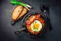 Letscho - tasty Hungarian vegetable stew with peppers, tomatoes and onions, served with bacon and fried egg Royalty Free Stock Photo