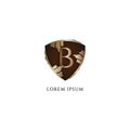 Letter B alphabet logo design template. Luxury Decorative metallic gold shield sign illustration. Initial abjad logo concept