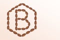 Letter B of the English alphabet from nuts in hexagon shape. Food pattern made from nuts alphabet for shop and diet