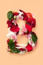 Letter B made from red roses and petals on a white background Royalty Free Stock Photo