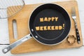 Letter biscuits word HAPPY WEEKEND and cooking equipments.