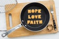 Letter biscuits word HOPE LOVE FAITH and cooking equipments. Royalty Free Stock Photo