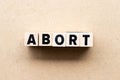 Letter block in word abort on wood background