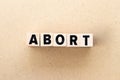 Letter block in word abort on wood background