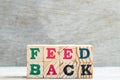 Letter block in word feedback on wood background Royalty Free Stock Photo