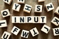 Letter block in word input with another block on wood background Royalty Free Stock Photo