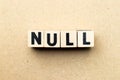 Letter block in word null on wood background