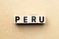 Letter block in word Peru on wood background