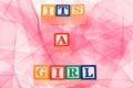 Letter blocks spelling 'its a girl'