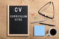 Letter board with message `CV - curriculum vitae` and office utensils Royalty Free Stock Photo