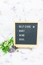 Letter board with phrase Self care, body, mind, soul with heart. Concept of mental health, mindfulness, self love. Aspiration,