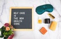 Letter board with phrase self care is the new health care background, sleeping mask, organic natural essential oil,skincare,