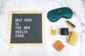 Letter board with phrase self care is the new health care background, sleeping mask, organic natural essential oil,skincare,