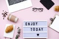 Letter Board Quote with coffee and croissant on pink background.