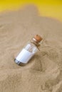 Letter in a bottle on the beach. Island lifestyle. Paper Message in a glass bottle with a cork on the sand. Note on Royalty Free Stock Photo