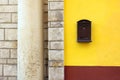 Cast-iron mail slot attached on a yellow wall Royalty Free Stock Photo