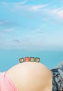 Letter boxes on pregnant woman belly Royalty Free Stock Photo