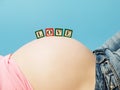 Letter boxes on pregnant woman belly Royalty Free Stock Photo