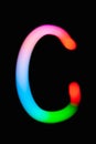 Letter C. Glowing letters on dark background. Abstract light painting at night. Creative artistic colorful bokeh. New Year. Royalty Free Stock Photo