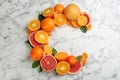 Letter C made with citrus fruits on marble table as vitamin representation Royalty Free Stock Photo
