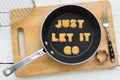 Letter cookies quote JUST LET IT GO and kitchen utensils