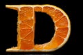 The letter D artistically shaped from orange slices against a black background