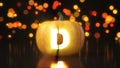 Letter D carved on Halloween pumpkin. 3d illustration with bokeh effect on background