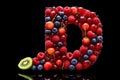 The letter D creatively formed with a variety of fresh and juicy berries and fruits