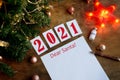 letter dear santa on a wooden background with the numbers 2021, a blank sheet of paper, covid-19 vaccine, led is a garland, a red Royalty Free Stock Photo