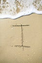 Letter drawn on the sand beach Royalty Free Stock Photo