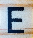 Letter E laser engraved on balsa wood macro close up texture detail Royalty Free Stock Photo