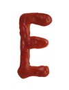 Letter E written with ketchup on white background Royalty Free Stock Photo